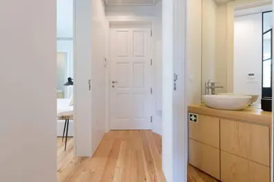 a bathroom with a sink and a white door at Quayside Douro River in Porto