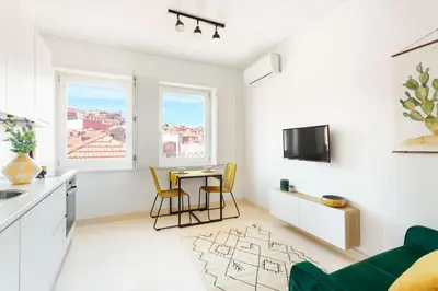 a kitchen and living room with a table and chairs at Oporto Amazing View Apartment in Porto