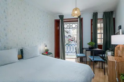 a bedroom with a white bed in a room at Renovated Feb25 Clerigos Cozy Balcony with self check in in Porto