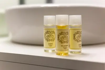 three bottles of oil sitting on a shelf at DA'HOME - Rola Art Work Studio in Porto