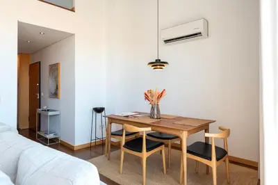 a dining room with a table and chairs and a bed at Sunny Loft in Downtown Porto with Private Parking in Porto