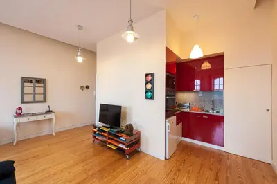 a living room with a tv and a kitchen at Studio with terrace @ historic center in Porto