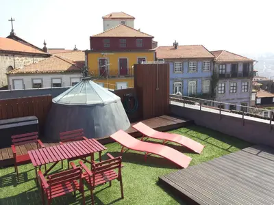 a balcony with a table and chairs and a tent at Studio with terrace @ historic center in Porto