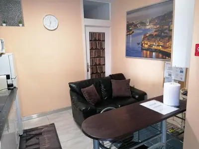 a living room with a leather couch and a table at House Romantic R/C left in Porto