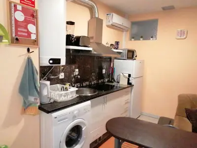 a kitchen with a washing machine and a washer at House Romantic R/C left in Porto