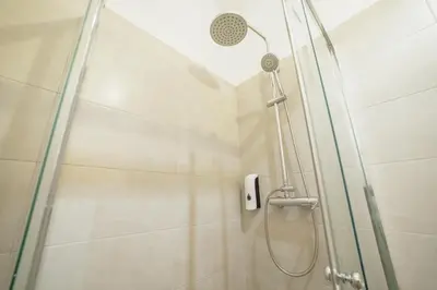 a shower with a shower head in a bathroom at A Portuense in Porto
