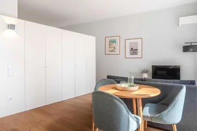 a bedroom with a white bed with two night stands at Uma Formosa Apartments in Porto