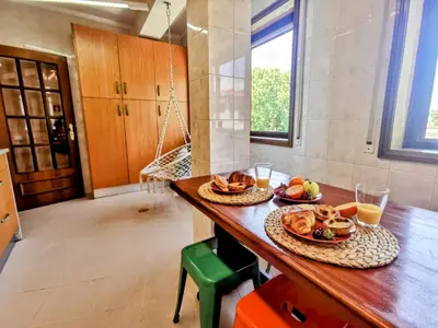 a kitchen with a table with plates of food on it at Coronel Pacheco 42 - Porto in Porto