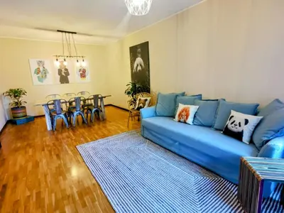 a living room with a blue couch and a table at Coronel Pacheco 42 - Porto in Porto