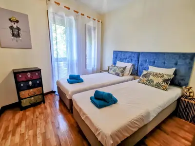 a bedroom with two beds with blue pillows on them at Coronel Pacheco 42 - Porto in Porto