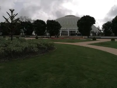 a large building with a green dome in a park at House Romantic II in Porto