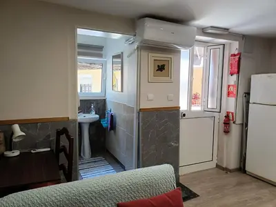 a small kitchen with a sink and a refrigerator at House Romantic II in Porto