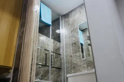 a shower with a glass door in a bathroom at House Romantic II in Porto