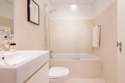 a white bathroom with a sink and a toilet at Decompress at a Tranquil, Minimal Urban Oasis with an Edge in Porto