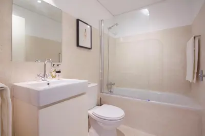a bathroom with a sink and a toilet and a tub at Decompress at a Tranquil, Minimal Urban Oasis with an Edge in Porto