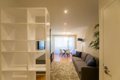 a living room with a couch and a table at Chic Alves Apartment in Porto