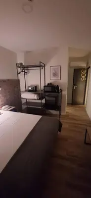 a hotel room with two beds and a television at Hotel Portucalense in Porto