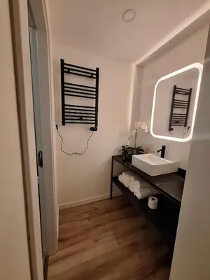 a bathroom with a sink and a mirror at Hotel Portucalense in Porto