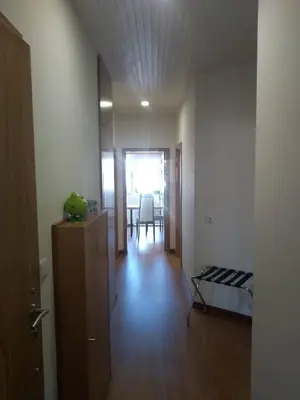 a room with a hallway with a bed and a table at Alegria Downtown Apartments in Porto
