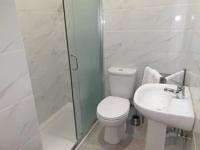 a bathroom with a toilet and a sink and a shower at Alegria Downtown Apartments in Porto
