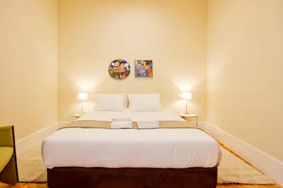 a bedroom with a large white bed with two lamps at Ribeira - Dixos Oporto Apartments III in Porto