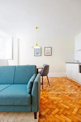 a living room with a blue couch and a table at Ribeira - Dixos Oporto Apartments III in Porto