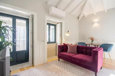 a living room with a purple couch and a table at Porto Toja Apartments in Porto