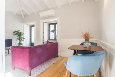 a living room with a purple couch and a table at Porto Toja Apartments in Porto
