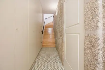 a hallway with a white door and a staircase at Porto Toja Apartments in Porto