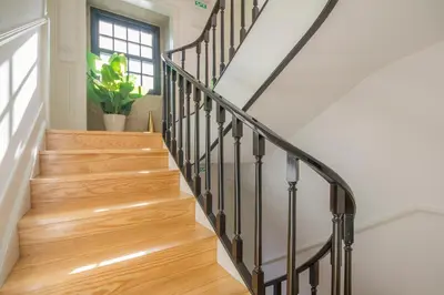 a staircase with wooden floors and a window at Porto Toja Apartments in Porto