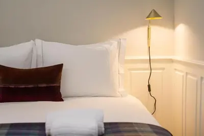 a bedroom with a white bed with a lamp at Porto Toja Apartments in Porto