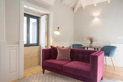 a living room with a purple couch and a table at Porto Toja Apartments in Porto