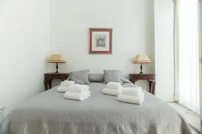 a white bed with four white pillows on it at Sweet Bainharia by Porto City Hosts in Porto