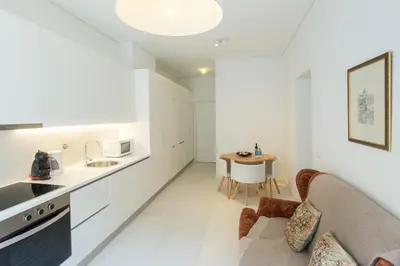 a kitchen and living room with a couch and a table at Sweet Bainharia by Porto City Hosts in Porto