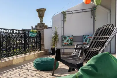 a patio with two chairs and a table on a balcony at Virtudes Terrace in Porto