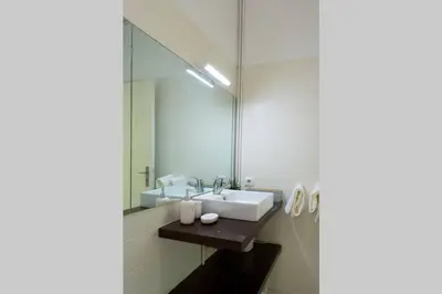 a bathroom with a sink and a mirror at Virtudes Terrace in Porto