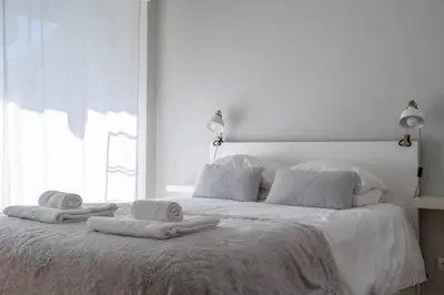 a white bed with towels on top of it at Virtudes Terrace in Porto