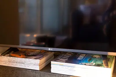 two books sitting on a table with a television at Virtudes Terrace in Porto