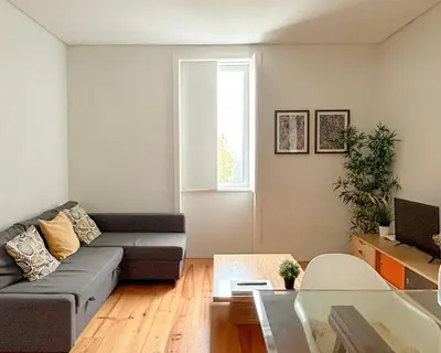 a living room with a couch and a table at Guest House Arca de Água in Porto