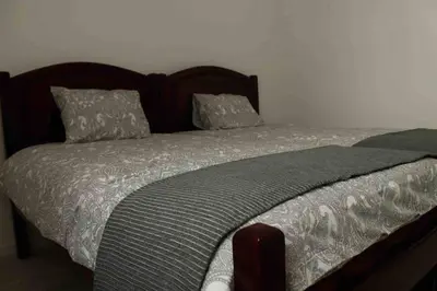 a bed with a wooden headboard and pillows on it at City Heart Place 3 in Porto