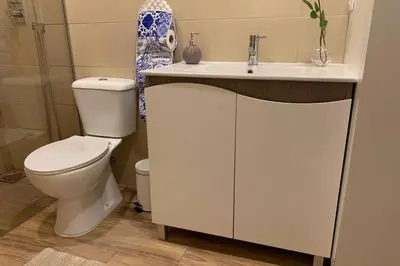 a white bathroom with a toilet and a sink at City Heart Place 3 in Porto