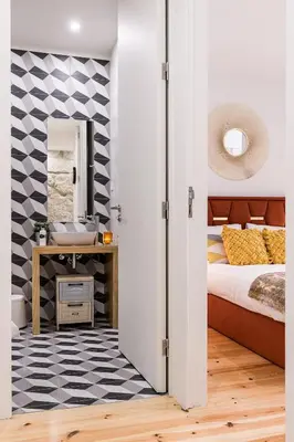 a bedroom with a bed and a sink and a mirror at Vintage Luxury House in Porto