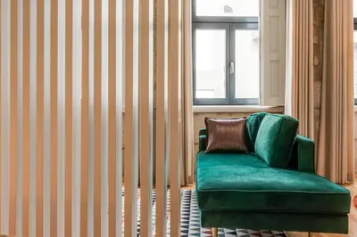 a green chair in a room with a window at Vintage Luxury House in Porto