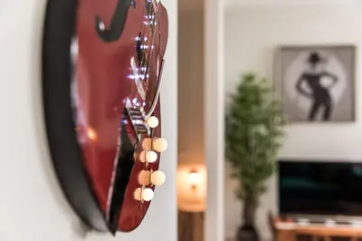 a mirror hanging on a wall with a guitar at Vintage Luxury House in Porto