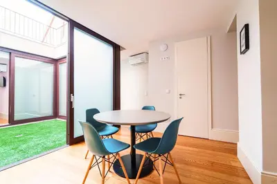 a dining room with a table and chairs at Morar Apartments Porto in Porto