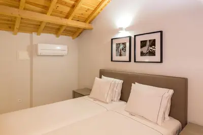 a bedroom with a bed and two pillows at Morar Apartments Porto in Porto