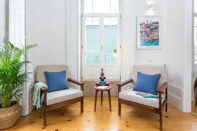 two chairs and a table in a living room at Alegria 283 in Porto