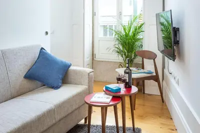a living room with a couch and a table at Alegria 283 in Porto
