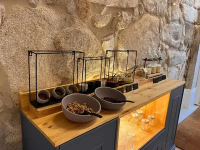 a wooden counter with bowls of food on it at Oportoflag center in Porto