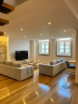 a living room with couches and a flat screen tv at Oportoflag center in Porto